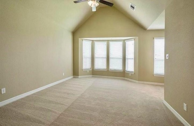 carpeted empty room with ceiling fan and lofted ceiling