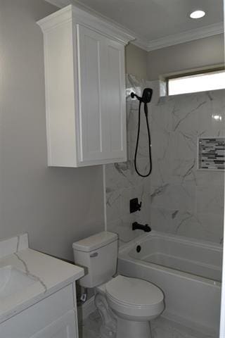 full bathroom featuring tiled shower / bath, vanity, crown molding, and toilet