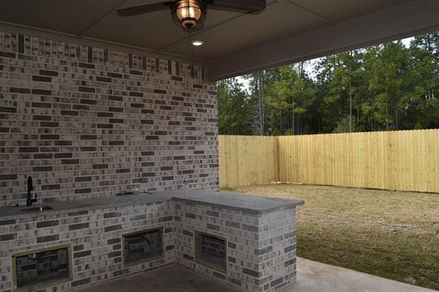 view of patio featuring ceiling fan