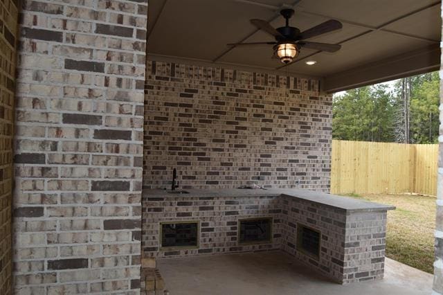 view of patio featuring ceiling fan