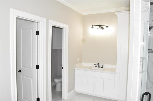 bathroom featuring vanity, an enclosed shower, ornamental molding, and toilet