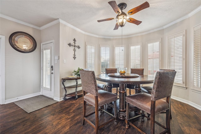 dining area featuring dark wood-type flooring, plenty of natural light, crown molding, and a textured ceiling