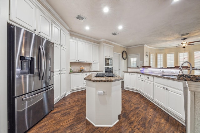 kitchen featuring white cabinetry, a kitchen island, dark stone countertops, and black appliances