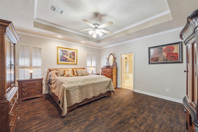 bedroom featuring crown molding, dark hardwood / wood-style flooring, a raised ceiling, and a textured ceiling