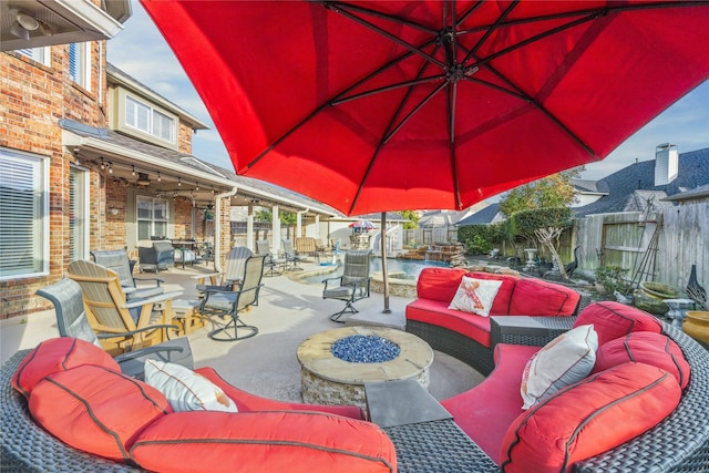 view of patio / terrace featuring an outdoor living space with a fire pit