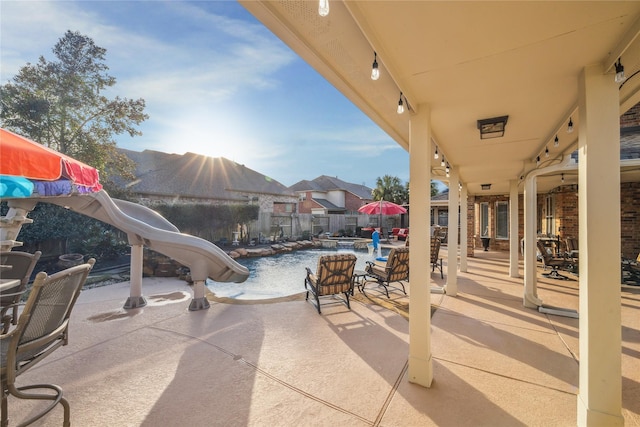 view of patio / terrace with a fenced in pool and a mountain view