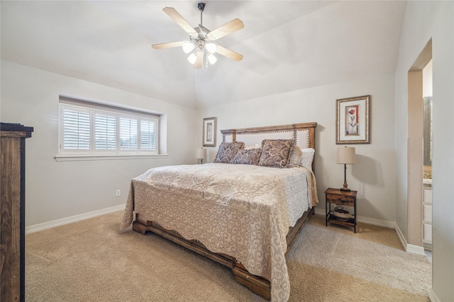 bedroom featuring vaulted ceiling, light colored carpet, and ceiling fan