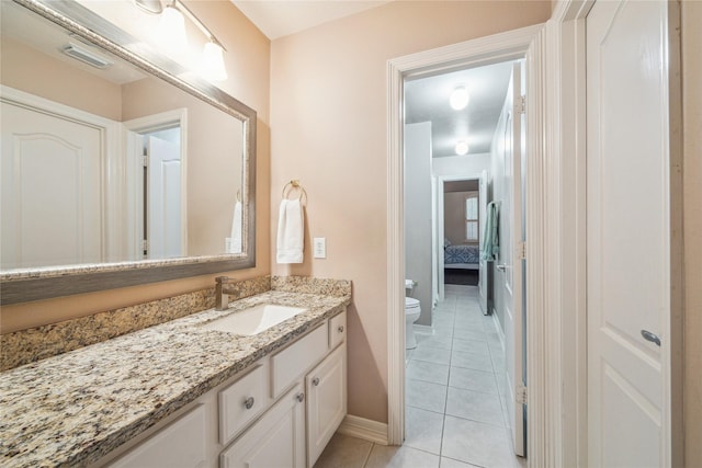 bathroom with tile patterned flooring, vanity, and toilet