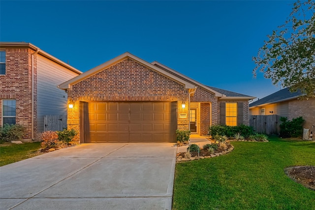 view of front of property featuring a garage and a yard