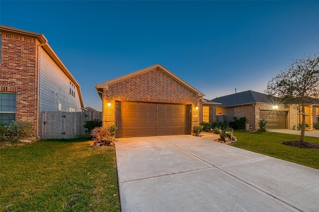 view of front of house with a yard and a garage