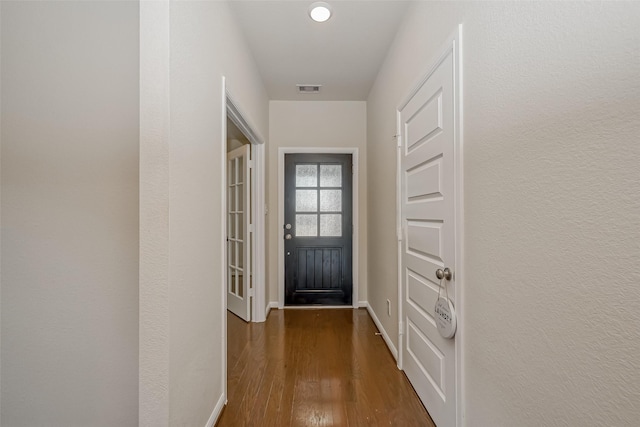 entryway with dark hardwood / wood-style flooring