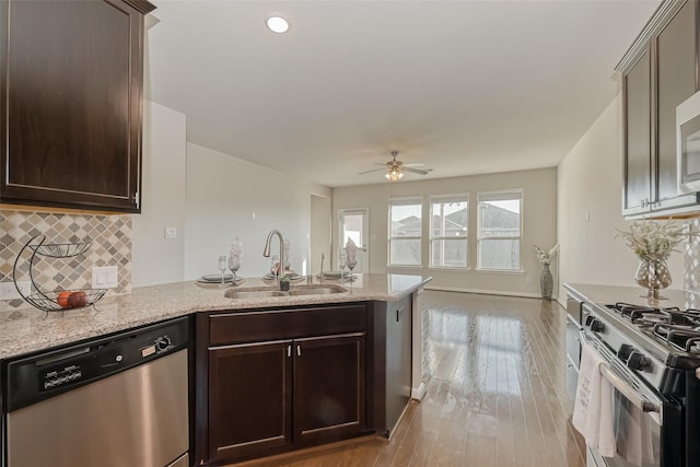 kitchen featuring tasteful backsplash, stainless steel appliances, sink, and dark brown cabinets