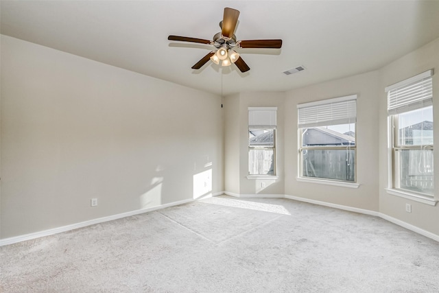 spare room with light colored carpet and ceiling fan