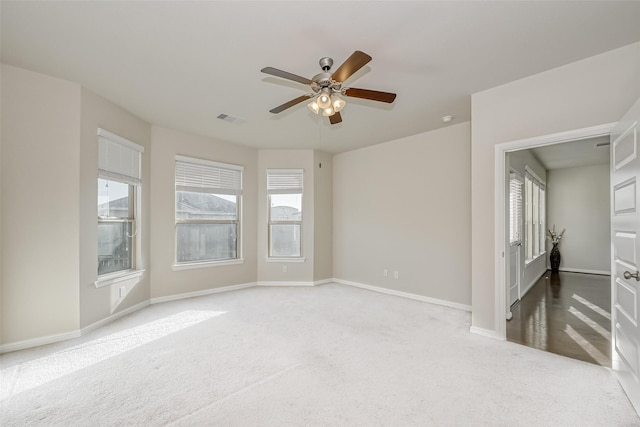 empty room featuring carpet floors and ceiling fan