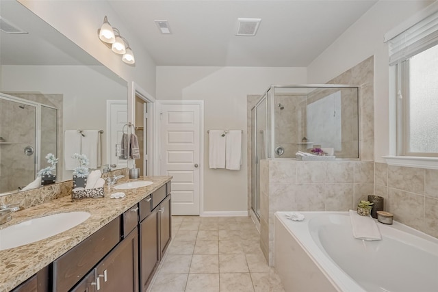 bathroom with tile patterned flooring, shower with separate bathtub, and vanity