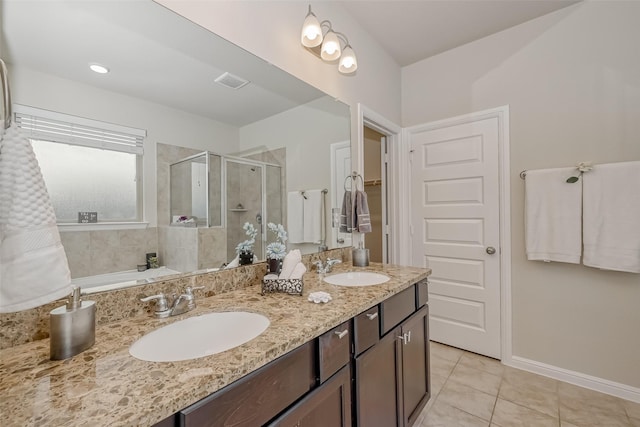 bathroom with vanity, an enclosed shower, and tile patterned floors