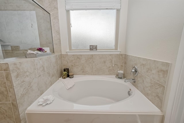 bathroom with a bathing tub and a wealth of natural light