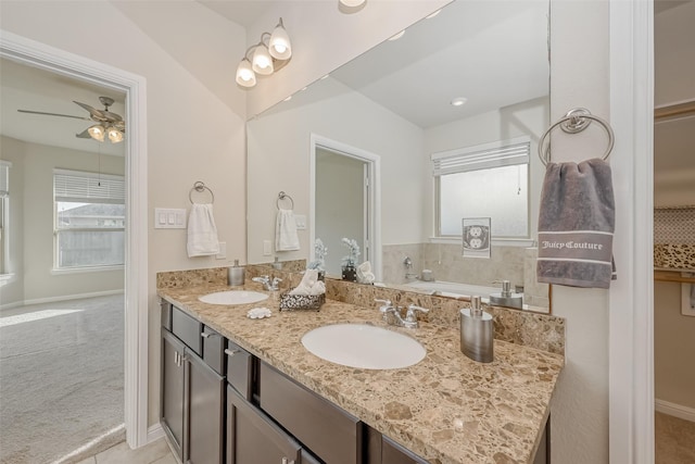 bathroom featuring vanity, ceiling fan, and a tub to relax in