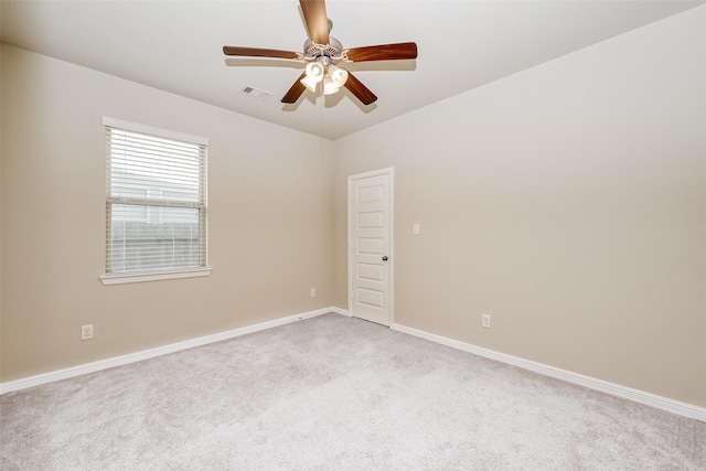 carpeted empty room featuring ceiling fan