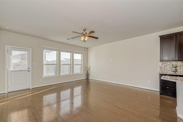 unfurnished living room featuring ceiling fan, plenty of natural light, and hardwood / wood-style floors