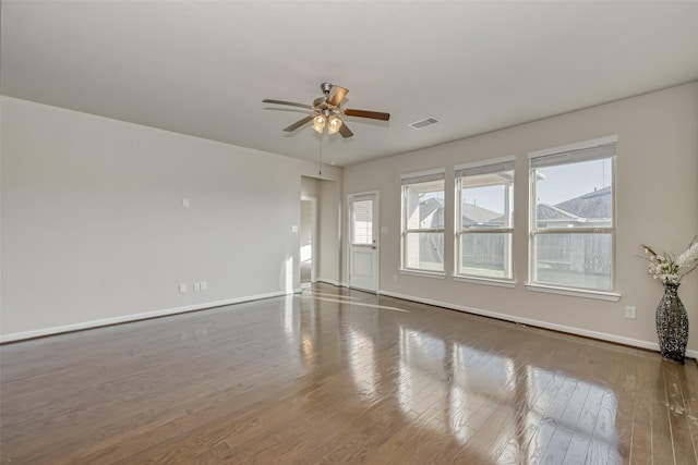 spare room with dark hardwood / wood-style flooring and ceiling fan