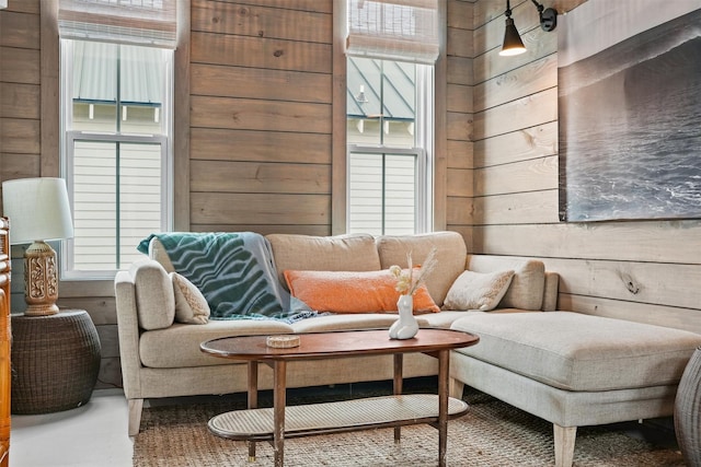 sitting room featuring a wealth of natural light and wood walls