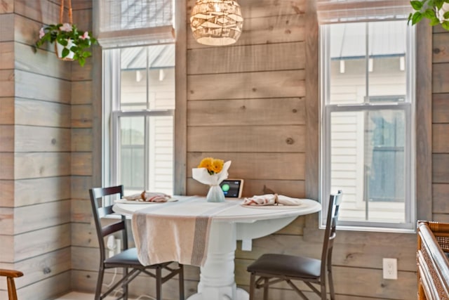 dining area featuring hardwood / wood-style flooring and wood walls