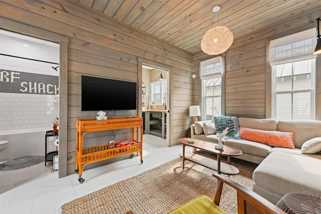 living room featuring plenty of natural light, wooden walls, and wooden ceiling