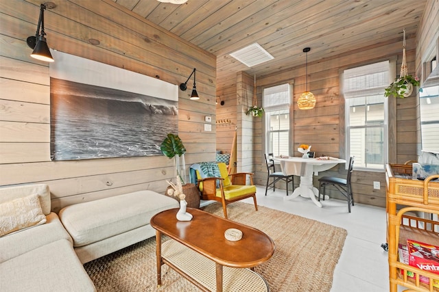 living room with wood ceiling and wooden walls