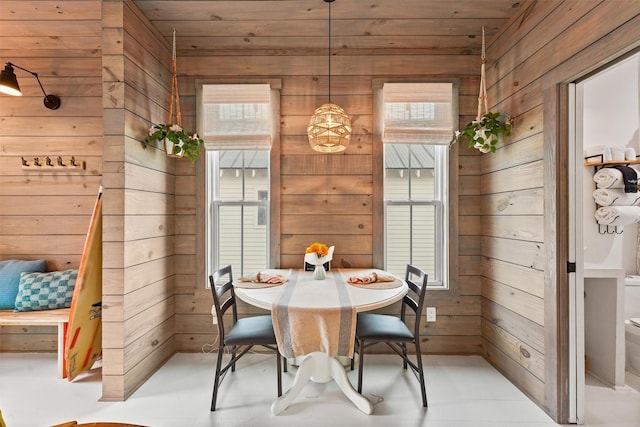 unfurnished dining area with wood walls