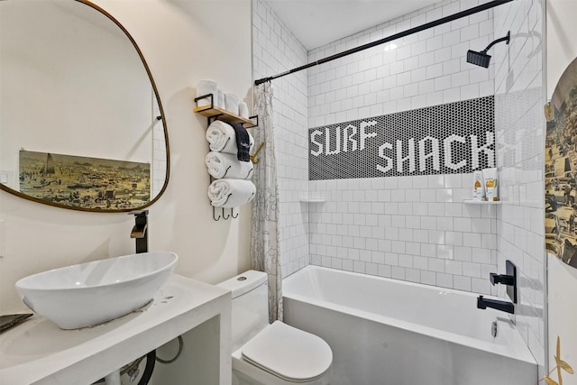 full bathroom featuring tiled shower / bath, sink, and toilet