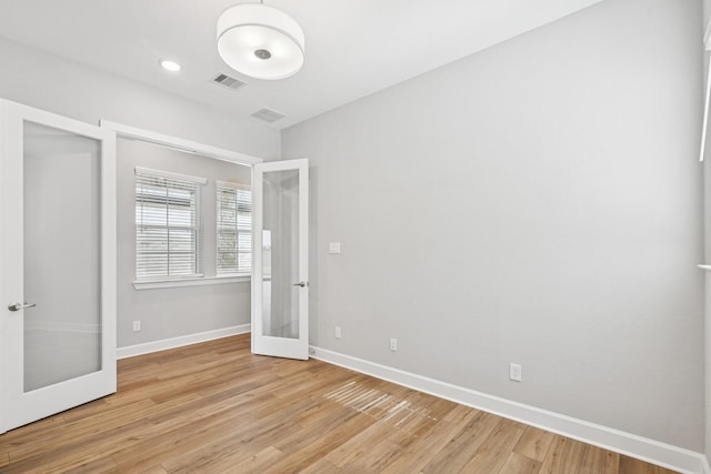 20406 Magnolia Flint Dr, Cypress, TX 77433 - unfurnished bedroom featuring french doors and light wood-style floors