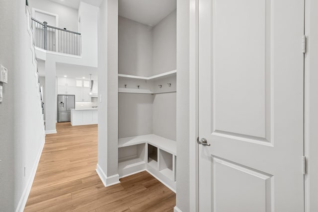 20406 Magnolia Flint Dr, Cypress, TX 77433 - mudroom featuring light wood-type flooring and baseboards