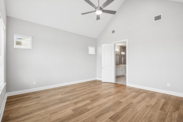20406 Magnolia Flint Dr, Cypress, TX 77433 - unfurnished bedroom featuring high vaulted ceiling, light wood finished floors, ensuite bath, and a ceiling fan