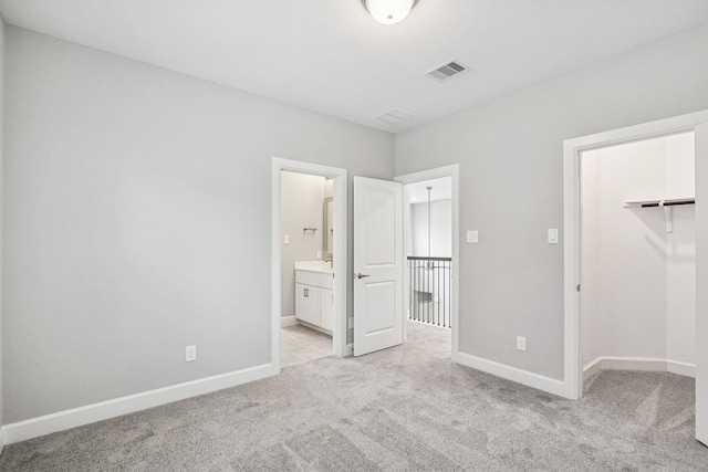 20406 Magnolia Flint Dr, Cypress, TX 77433 - unfurnished bedroom featuring light colored carpet, a spacious closet, and connected bathroom
