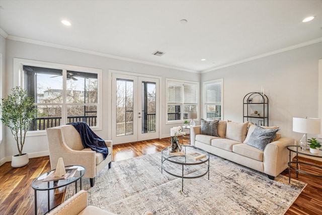 living room with ornamental molding, hardwood / wood-style floors, and french doors