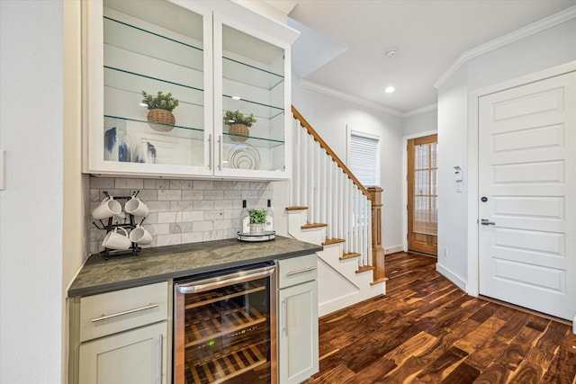 bar featuring white cabinetry, backsplash, ornamental molding, dark hardwood / wood-style flooring, and beverage cooler