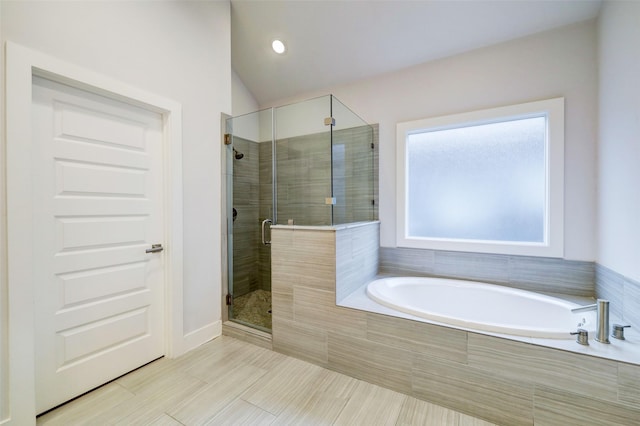 bathroom with vaulted ceiling and shower with separate bathtub