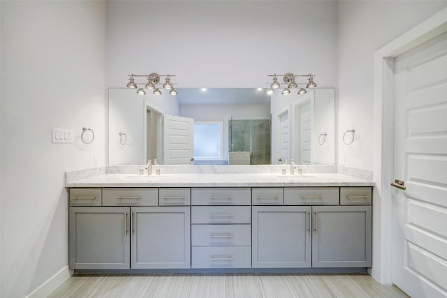 bathroom featuring vanity and a shower with shower door