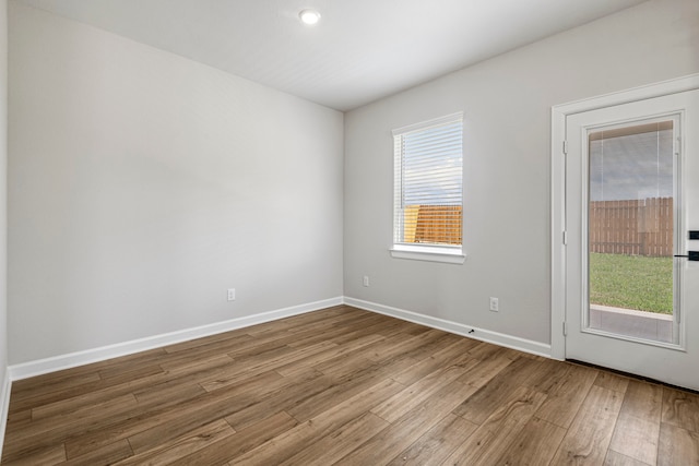 unfurnished room with hardwood / wood-style flooring