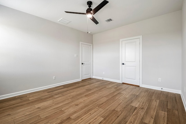 empty room featuring hardwood / wood-style floors and ceiling fan