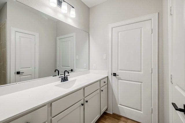 bathroom featuring vanity and wood-type flooring