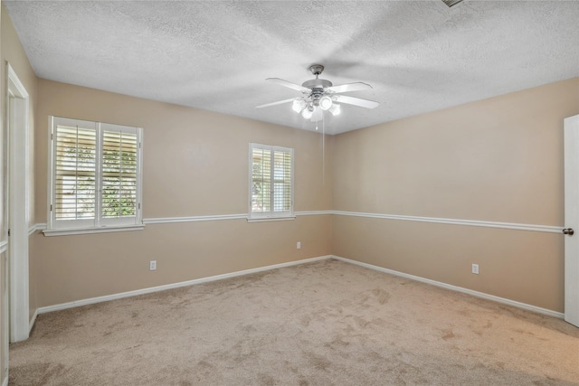 carpeted empty room featuring a textured ceiling and ceiling fan