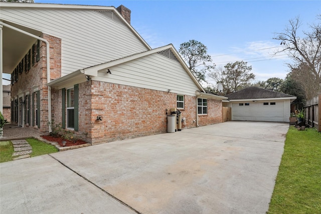 view of property exterior with a garage and an outdoor structure