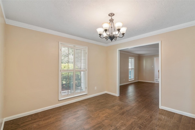 empty room with an inviting chandelier, dark hardwood / wood-style flooring, a textured ceiling, and crown molding