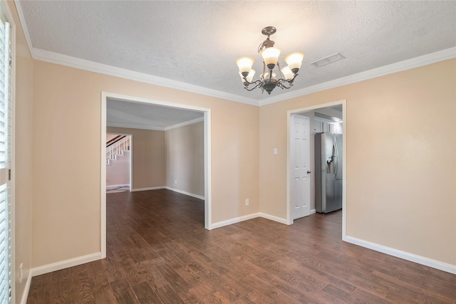 empty room with ornamental molding, dark hardwood / wood-style flooring, a textured ceiling, and a notable chandelier