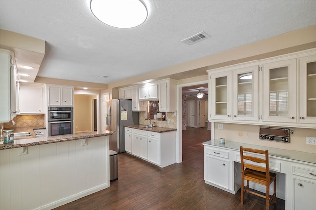 kitchen featuring sink, white cabinetry, stainless steel appliances, light stone countertops, and dark hardwood / wood-style flooring