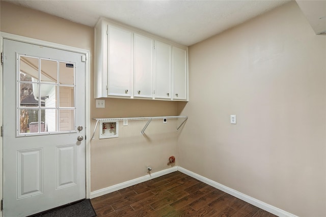 laundry area with gas dryer hookup, cabinets, hookup for a washing machine, dark wood-type flooring, and hookup for an electric dryer