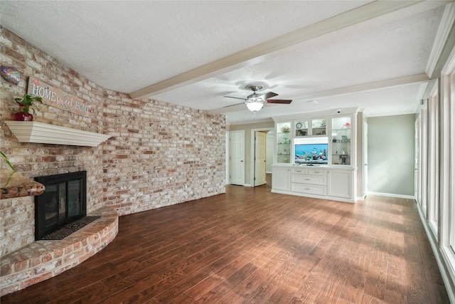 unfurnished living room with beam ceiling, a fireplace, hardwood / wood-style floors, and a textured ceiling