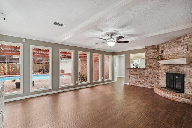 unfurnished living room with hardwood / wood-style floors, a fireplace, ceiling fan, crown molding, and a textured ceiling